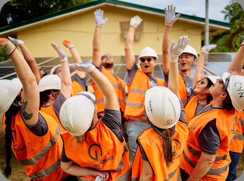 Volunteers and community members gathered around a GivePower solar water project