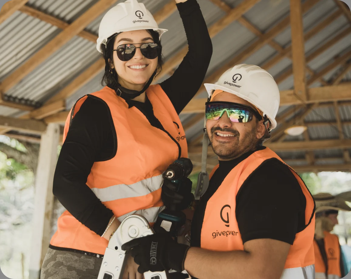Trek participants working together on a solar installation