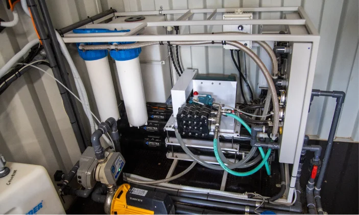 Reverse osmosis water treatment skid with membrane housings, pre-filters and a high-pressure pump